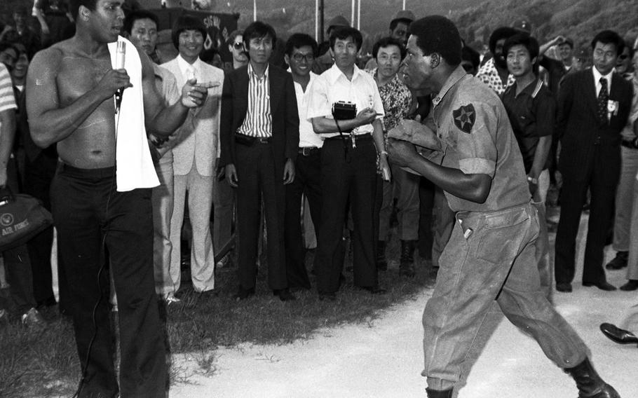 Muhammad Ali, during a visit with 2nd Infantry Division troops at the Shoonover Bowl outdoor theater, near the Korean DMZ, in June, 1976. Ali, who had recently taken part in a boxing-wrestling match against Antonio Inoki in Tokyo, was greeted by thousands of Koreans who lined his motorcade route from the airport to Seoul.