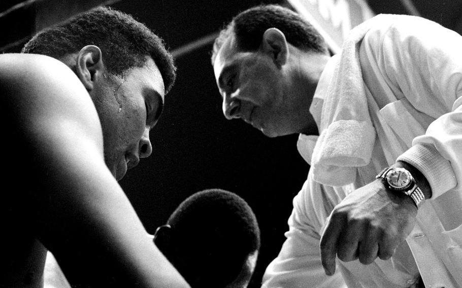 World heavyweight champion Muhammad Ali listens to his cornerman, Angelo Dundee, during his fight with European champ Karl Mildenberger at Frankfurt's Forest Stadium in September, 1966. Ali beat Mildenberger in 12 rounds, giving the 24-year-old his 26th win (without a loss) as a professional.