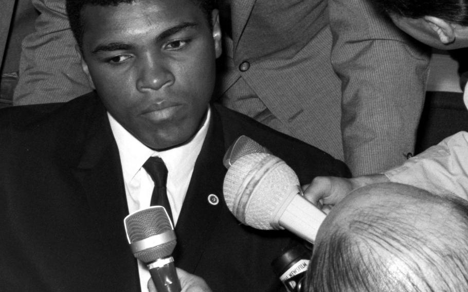 Muhammad Ali meets with reporters at the Frankfurt airport in August, 1966. Ali was preparing for his upcoming fight with European champion Karl Mildenberger.