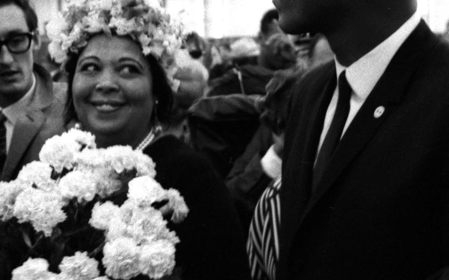 Mrs. Odessa Lee Grady Clay proudly watches as her son, world heavyweight boxing champion Muhammad Ali, makes his way through a crowd of admirers at the Frankfurt airport in August, 1966. Mother and son were arriving in Germany for Ali's upcoming fight with European champion Karl Mildenberger.