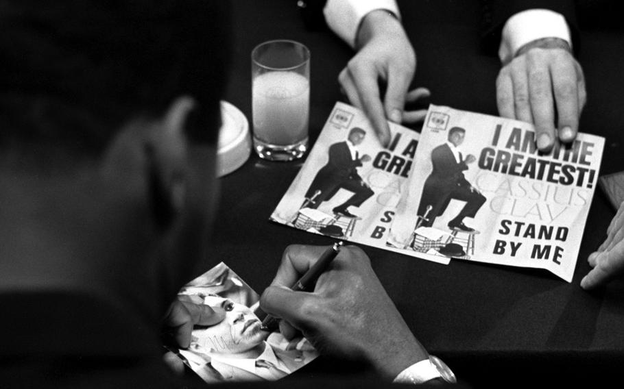 Muhammad Ali signs autographs during a press conference at the Intercontinental Hotel in Frankfurt, West Germany, in August, 1966. Ali was to defend his heavyweight boxing title against European champion Karl Mildenberger in mid-September.