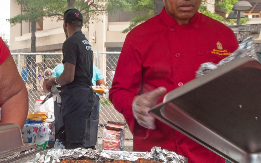 Marine veteran Master Gunnery Sgt. Jeremiah Burns unveils his dish during the Military Chef Cook-Off - part of the Annual Giant National Capital Barbecue Battle - in Washington, D.C., on June 25, 2016.