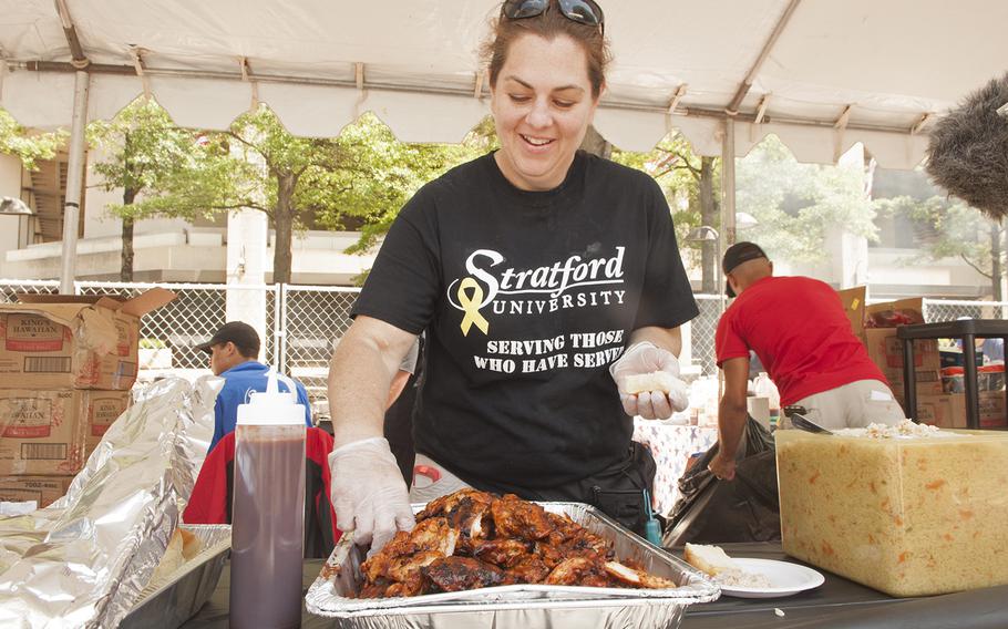 Ret. U.S. Air Force Staff Sgt. Jennifer Sondheimer finishes preparing her meal during the Military Chef Cook-Off - part of the Annual Giant National Capital Barbecue Battle - in Washington, D.C., on June 25, 2016.