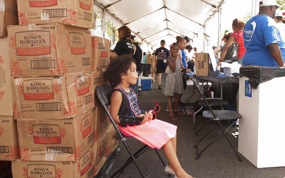 A little girl waits patiently inside the tent during the Military Chef Cook-Off - part of the Annual Giant National Capital Barbecue Battle - in Washington, D.C., on June 25, 2016.