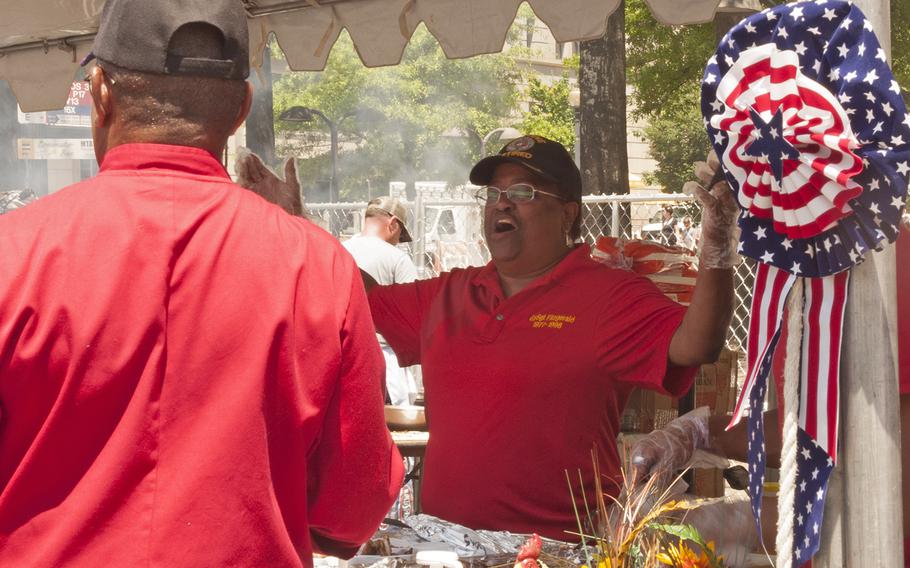 A member of the U.S.M.C. team sings the Marines' Hymn (The Halls of Montezuma) during the Military Chef Cook-Off - part of the Annual Giant National Capital Barbecue Battle - in Washington, D.C., on June 25, 2016. The team from the U.S. Coast Guard, which was located next to the U.S.M.C., took up the challenge next, and started to sing Semper Paratus. 