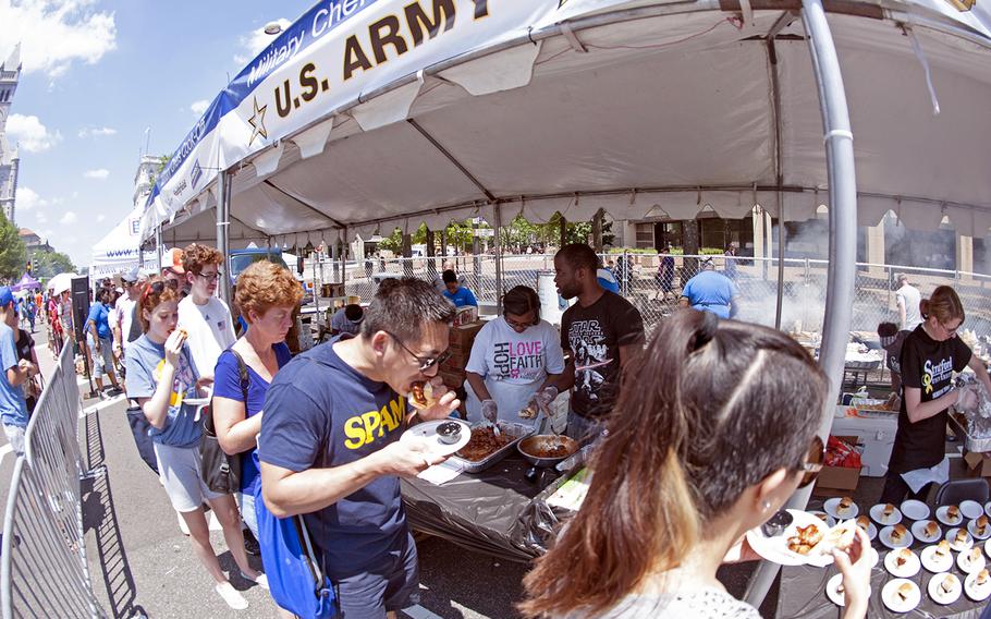 Visitors sample the fare at the U.S. Army table during the Military Chef Cook-Off - part of the Annual Giant National Capital Barbecue Battle - in Washington, D.C., on June 25, 2016.