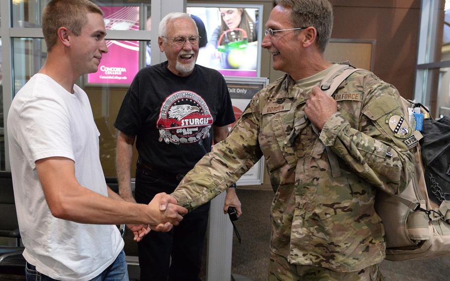 In a 2015 file photo, three generations of North Dakota Air National Guard members get together at Hector International Airport in Fargo. Master Sgt. Scot Gordon, right, is greeted by his father, retired Lt. Col. Earl "Shell" Gordon, center, and his son, Airman 1st Class Trevor Gordon upon Scot's return from a six-month deployment to Afghanistan.