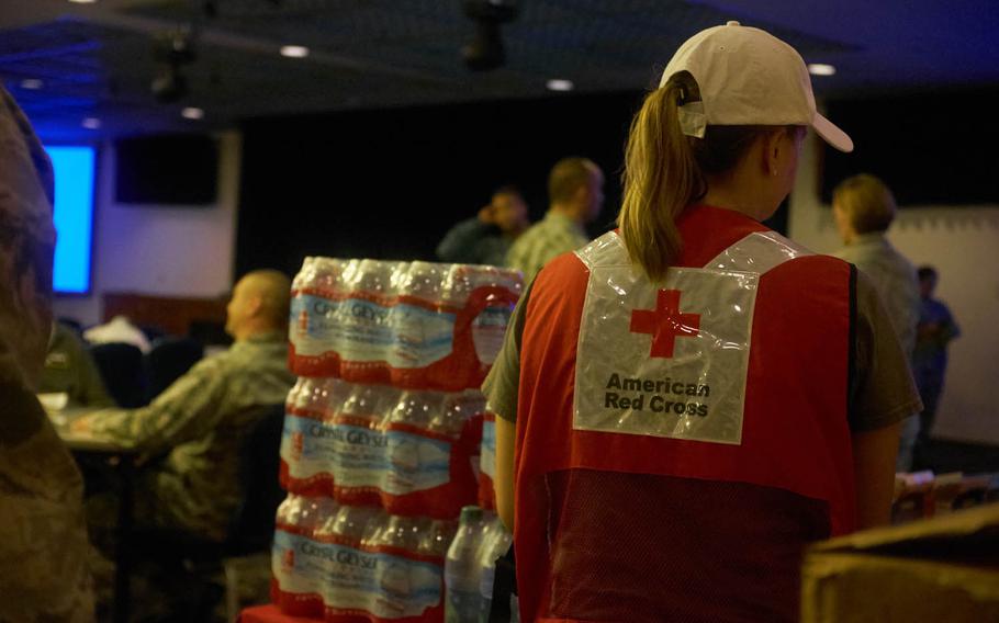 The American Red Cross distributes free bottled water and nonperishable food to families, Tuesday, Aug. 23, 2016, at Yokota Air Base, Japan. More than 300 families stationed at the base were ordered to temporarily relocate after floodwaters cut electricity and rendered fire-detection systems inoperable in several buildings.
