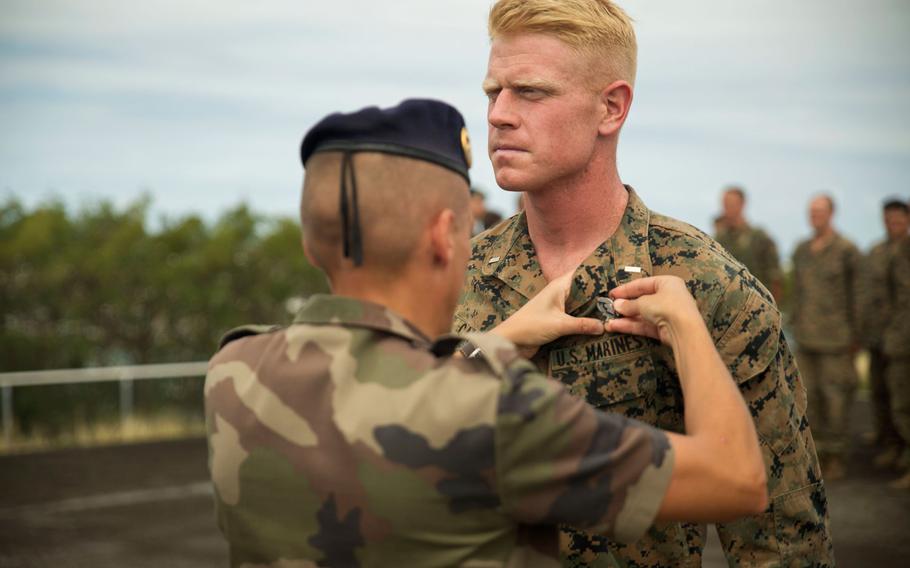 1st Lt. Ian M. Cameron, an infantry officer, receives a pin signifying the completion of a French Armed Forces Nautical Commando Course at Quartier Gribeauval, New Caledonia, Sept. 1, 2016. This marks the first U.S. forces ever to complete the course and receive these pins. The course is a part of Exercise AmeriCal 16, a bilateral training exercise designed to enhance mutual combat capabilities and improve relations between the U.S. Marine Corps and the French Armed Forces. Cameron, from Rochester, Minnesota, is with Marine Rotational Force – Darwin.