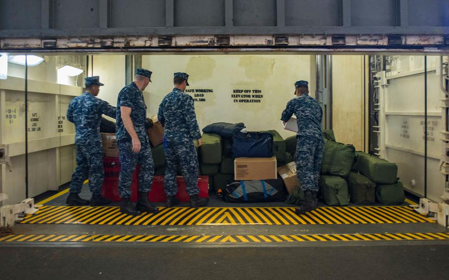 Weapons department Sailors stack medical supplies and personal gear in an elevator in the hangar bay of the USS Ronald Reagan (CVN 76). Ronald Reagan is preparing for her regularly scheduled patrol by on-loading supplies and equipment. Ronald Reagan and its embarked air wing, Carrier Air Wing (CVW) 5 provide a combat-ready force, which protects and defends the collective maritime interests of the U.S. and its allies and partners in the Indo-Asia-Pacific region.