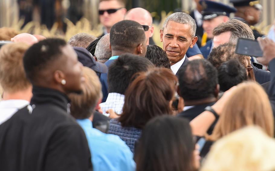 President Barack Obama shakes hands with survivors and family members of those who perished in the 9/11 attacks at the Pentagon during a ceremony Sunday morning marking the 15th anniversary of the attack. 