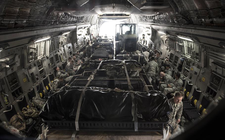 More than 30 members of the 621st Contingency Response Wing aboard a C-17 Globemaster III at Joint Base McGuire-Dix-Lakehurst, N.J. wait for equipment to be loaded on before takeoff on their way to Port-au-Prince, Haiti in response to Hurricane Matthew, October 6, 2016.