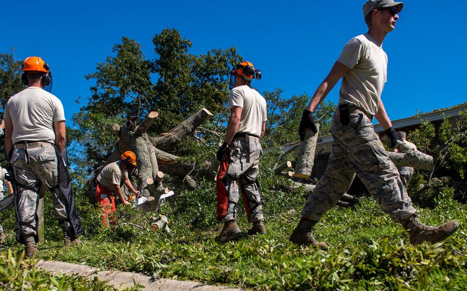 U.S. Air Force civil engineers with the 628th Civil Engineer Squadron, remove a fallen tree after  Hurricane Mathew swept through Hunley Park-Air Base housing, S.C., Oct. 9, 2016.   All non-essential personnel evacuated the area, but returned after disaster response coordinators assessed damage and verified a safe operating environment.