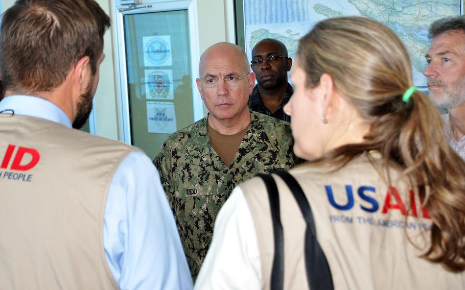 Adm. Kurt Tidd, commander of U.S. Southern Command, talks with U.S. Agency for International Development staff in Port-au-Prince, Haiti, during a visit Oct. 15 to U.S. troops assisting in Hurricane Matthew relief efforts. A U.S. military joint task force has been operating out of the international airport in the capital, helping to load and deliver USAID relief supplies by helicopters to the worst stricken areas in the country’s southwest.