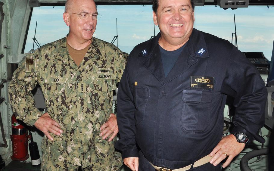 Adm. Kurt Tidd, Commander of U.S. Southern Command, left, shares a lighter moment with Capt. James Midkiff, commander of the amphibious assault ship Iwo Jima, during a visit to the ship on Oct. 15. The Iwo Jima arrived off the coast of Haiti on Oct. 13 and is now assuming the lead in delivering USAID relief supplies to areas hardest hit by Hurricane Matthew two weeks ago.