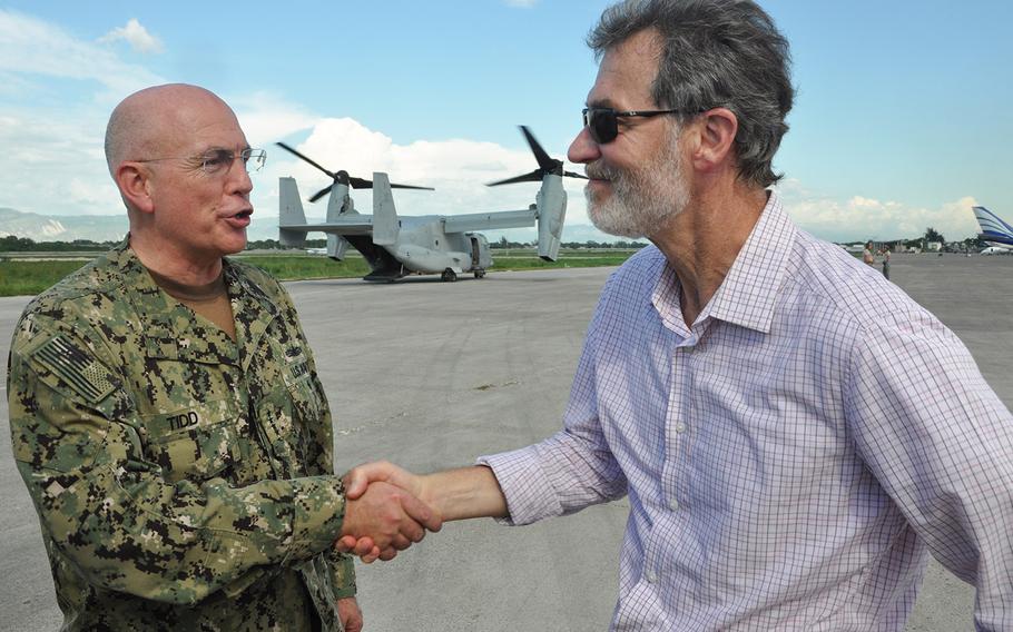 Adm. Kurt Tidd, Commander of U.S. Southern Command, left, shakes hands with U.S. Ambassador to Haiti Peter Mulrean during a visit on Oct. 15 to U.S. troops who are in the capital Port-au-Prince assisting in the hurricane relief efforts. A joint task force of the U.S. military has been operating out of the international airport in the capital, helping to unload, load and deliver USAID relief supplies by helicopters to the worst stricken areas in the country’s southwest.
