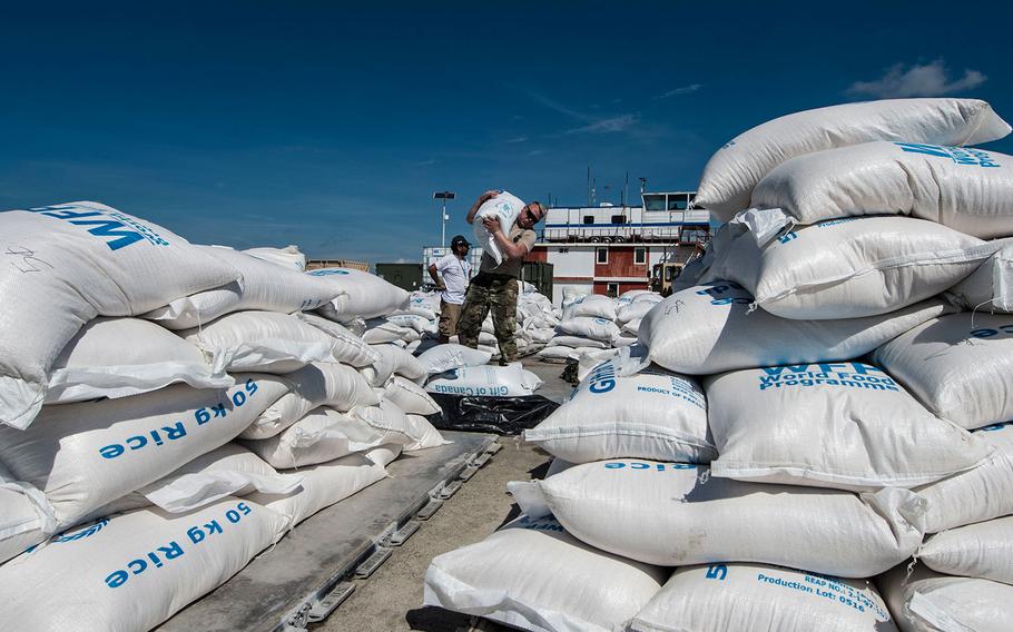 Spc. Jerimyha Pectol, 689th Rapid Port Opening Element, stages humanitarian aid intended for victims of Hurricane Matthew at Port-Au-Prince, Haiti, October 17th, 2016. 