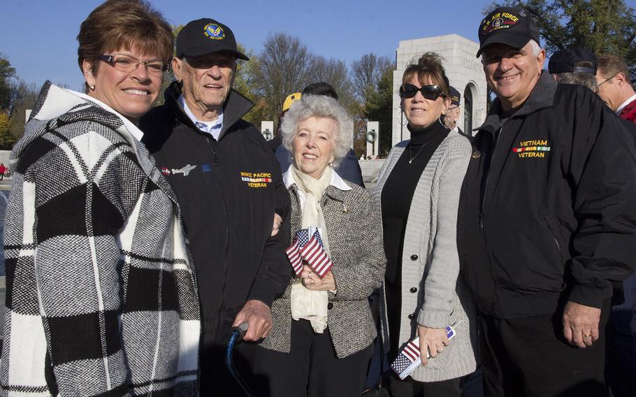World War II veteran Leo Rhenn, who served in the Army Air Corps, poses with family members before a Veterans Day ceremony at the National World War II Memorial in Washington, D.C., Nov. 11, 2016.