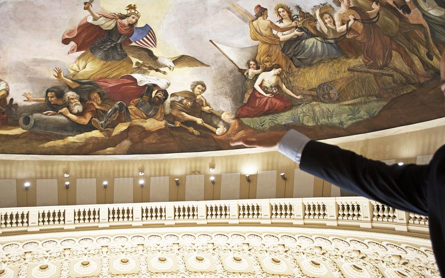 Detail of the Apotheosis of Washington in the Capitol dome. Joe Abriatis demonstrates how high the scaffolding reached during the restoration process at the Cupola level.