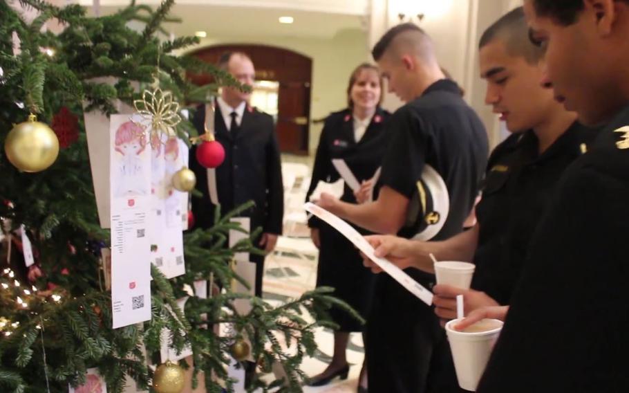 Naval Academy Midshipmen decorate the holiday tree in the rotunda of Bancroft Hall with paper angel ornaments provided by the Salvation Army. Each ornament has the first name, age, gender, clothing sizes and a wish list of items for children who are in need in the Annapolis area. 
