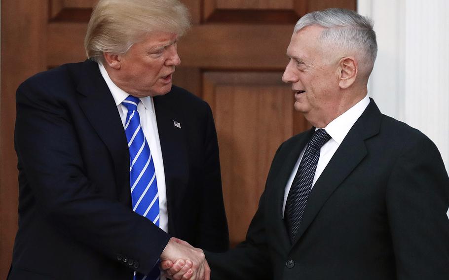 In a Nov. 19, 2016 file photo, President-elect Donald Trump shakes hands with retired Marine Corps Gen. James Mattis as he leaves Trump National Golf Club Bedminster clubhouse in Bedminster, N.J.
