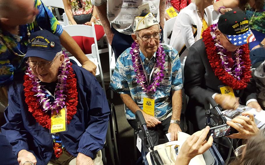 Survivors from the USS Arizona, which was destroyed and sunk during the Dec. 7, 1941, surprise attack by the Japanese, chat with guests before the start of a ceremony commemorating the 75th anniversary of the disaster, Wednesday, Dec. 7, 2016, at Joint Base Pearl Harbor-Hickam, Hawaii.
