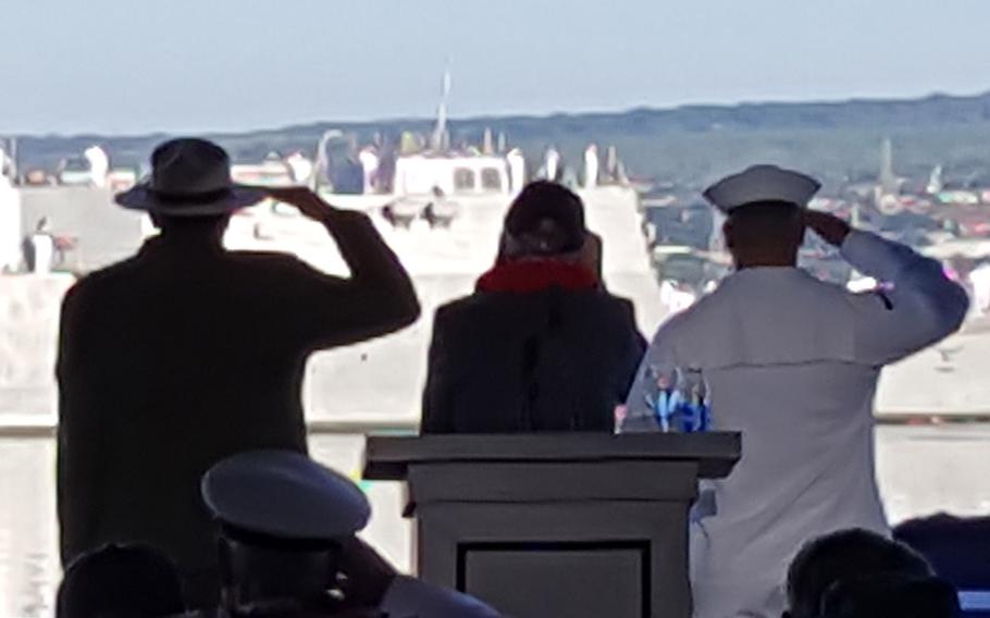 
Donald Stratton, center, returns honors to the USS Halsey as it passes in front of the pier at Pearl Harbor during the 75th anniversary remembrance, Wednesday, Dec. 7, 2016. Stratton, a sailor aboard the USS Arizona during the attack, narrowly escaped death but was severely burned over two-thirds of his body. 