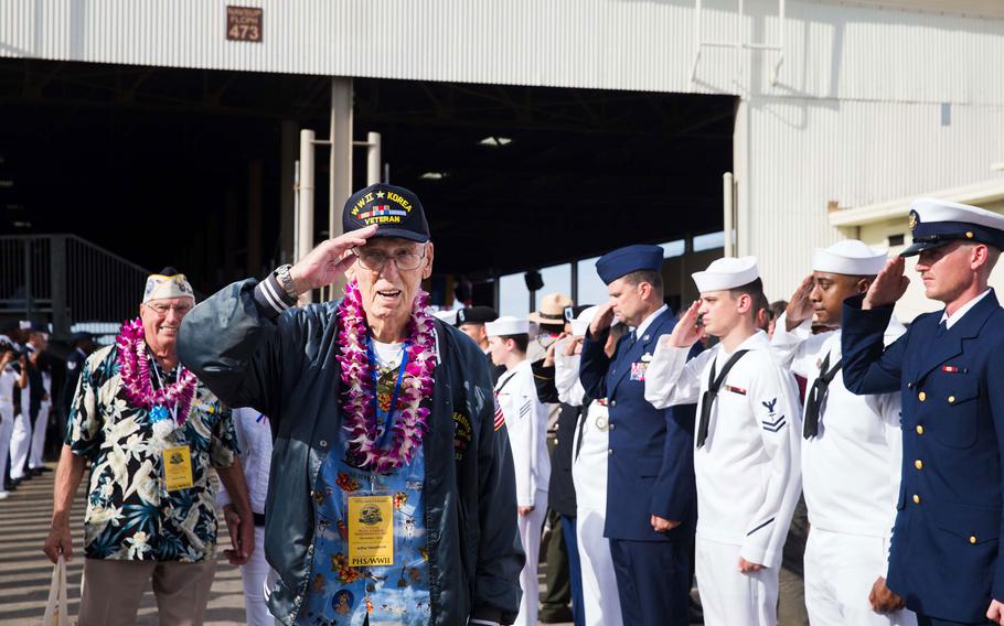Arthur Hasselbrink, a World War II and Korean War veteran, returns a salute to the honors cordon following the ceremony for the 75th anniversary of the attack on Pearl Harbor, Wednesday, Dec. 7, 2016, at Joint Base Pearl Harbor-Hickam, Hawaii.