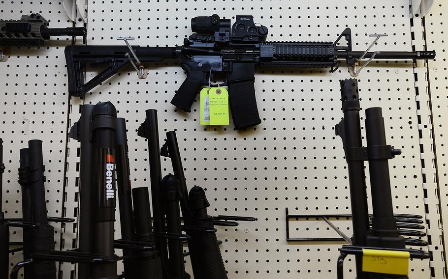 An AR-15 assault rifle featuring an EoTech optical sighting system and a 30-round magazine capacity is seen in a gun shop in North Carolina. 