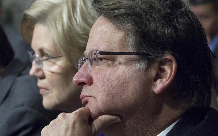 Sen. Gary Peters, D-Mich. , one of four new members of the Senate Armed Services Committee, listens to testimony during a hearing on cybersecurity, Jan. 5, 2017, on Capitol Hill. Next to him is another new committee member, Sen. Elizabeth Warren, D-Mass.