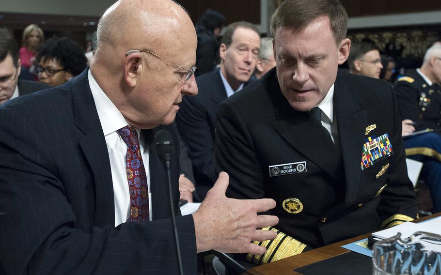 Director of National Intelligence James R. Clapper, Jr., left. talks with National Security Agency Director Adm. Michael S. Rogers before a Senate Armed Services Committee hearing on cybersecurity, Jan. 5, 2017, on Capitol Hill.