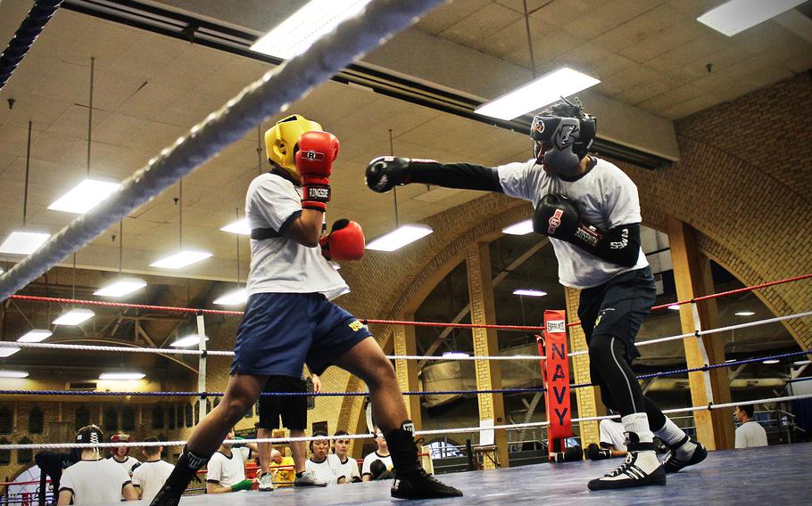Junior Matt Suarez,right, throws a punch at Senior Hitoshi Oue, during a sparing match at the United States Naval Academy before the semi-finals of the Brigade Championships. Both boxers will be fighting in the championships. 