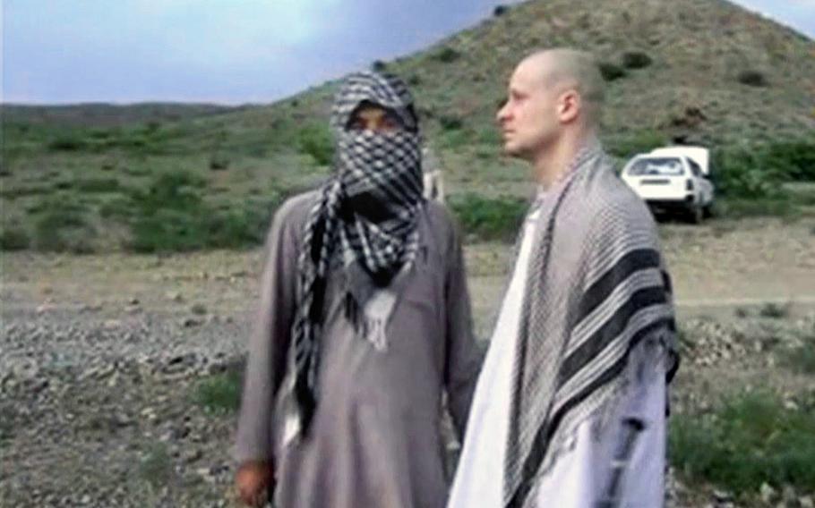 A video screen grab shows Army Sgt. Bowe Bergdahl, right, standing with a Taliban fighter in eastern Afghanistan. 