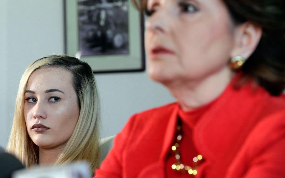 In a March 8, 2017 file photo, active-duty Marine Marisa Woytek, left, and attorney Gloria Allred announce at a Los Angeles press conference that photos of Woytek and of another former female Marine were secretly posted online without their consent.