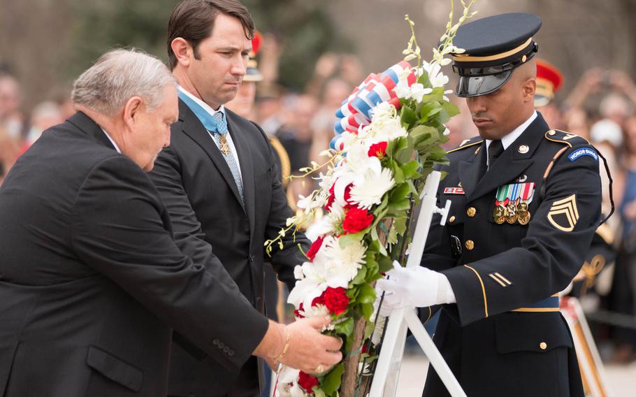 Mike Fitzmaurice, left, and Will Swenson, center, both Medal of Honor recipients, lay a wreath with the help of a soldier with the U.S. Army's 3rd Infantry Regiment "The Old Guard"at the Tomb of the Unknown Soldier at Arlington National Cemetery on Saturday, March 25, 2017. 