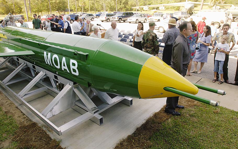 A group gathers around a GBU-43B, or massive ordnance air blast weapon, on display at the Air Force Armament Museum on Eglin Air Force Base near Valparaiso, Fla., in May 2004. The 21,600-pound "mother of all bombs," as it is sometimes called, is dwarfed by Russia’s Aviation Thermobaric Bomb of Increased Power, nicknamed the Father of All Bombs.