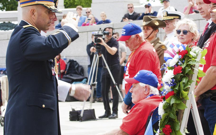 U.S. Army Col. Jayson Altieri and Capt. Marc Batsford, Canadian Forces Naval attache, salute a wreath at the Battle of the Coral Sea 75th Anniversary at the World War II Memorial in Washington, D.C., on May 4, 2017.