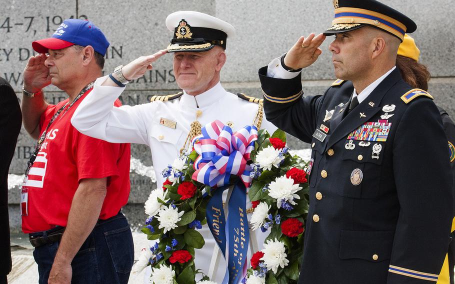 Col. Jayson Altieri, US Army, and Capt. Marc Batsford, Canadian Forces Naval attache, salute at the Battle of the Coral Sea 75th Anniversary at the World War II Memorial in Washington, D.C., on May 4, 2017. At the far left is the guardian for honor flight participant Ewin Aley. 