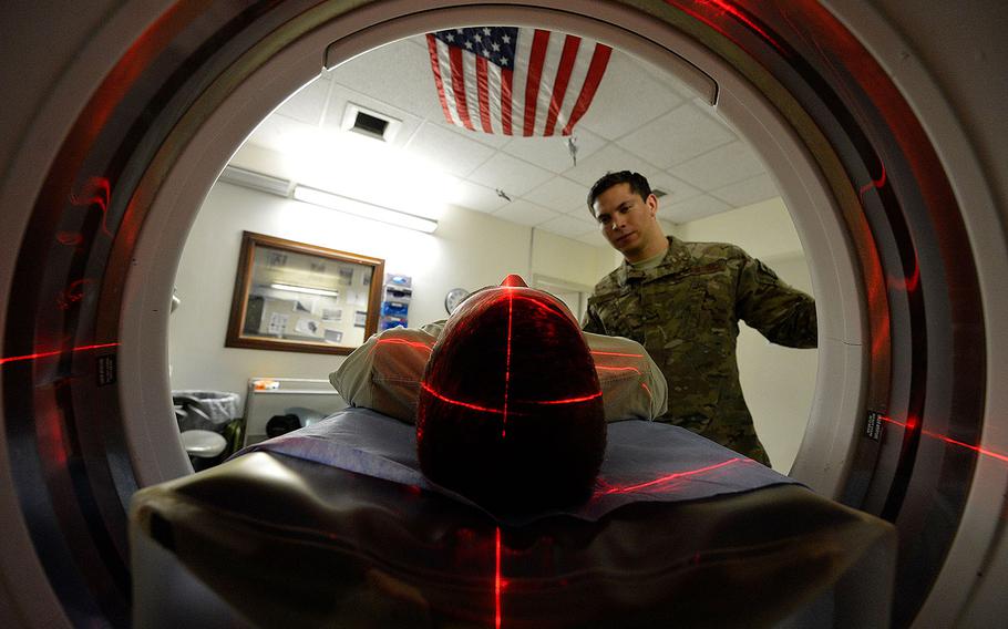 An airman positions a servicemember for a CT scan at Bagram Air Field in Afghanistan on July 24, 2014.