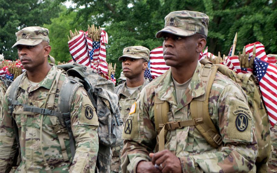 Soldiers with the 3rd U.S. Infantry Regiment (The Old Guard) prepare to place flags at Arlington National Cemetery during Flags In on May 25, 2017.