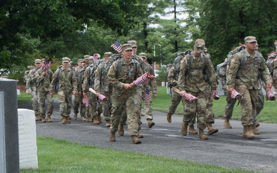 Soldiers with the 3rd U.S. Infantry Regiment (The Old Guard) prepare to place flags at Arlington National Cemetery during Flags In on May 25, 2017.