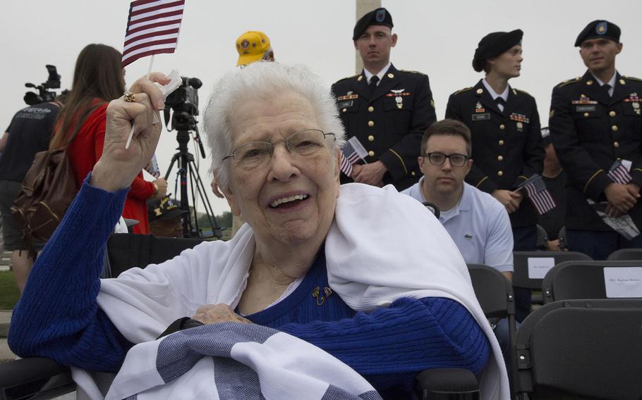 Betty Kearl, wife of World War II Navy veteran Clayton Kearl, waves a flag before Monday's Memorial Day ceremony at the National World War II Memorial in Washington, D.C. Clayton Kearl served on the USS Salt Lake City during the war.