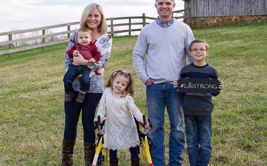 Lillianna Shull, 6, stands in front of her wheelchair for a family photo in December 2015. From left, Jen Shull holding youngest sibling Luke, 1, Maj. Michael Shull and eldest sibling Jake, who was 8. Lilli died of complications from brain cancer in February.
