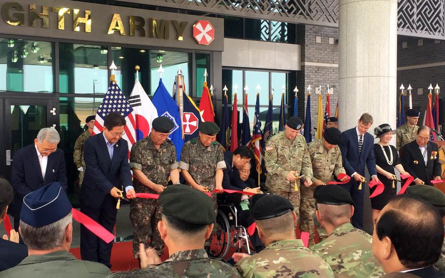 Army Lt. Gen. Thomas Vandal, fifth from right, and retired South Korean Gen. Paik Sun-yup, to his left, join other dignitaries for a ribbon-cutting ceremony to mark the opening of the new 8th Army headquarters at Camp Humphreys, South Korea, Tuesday, July 11, 2017.