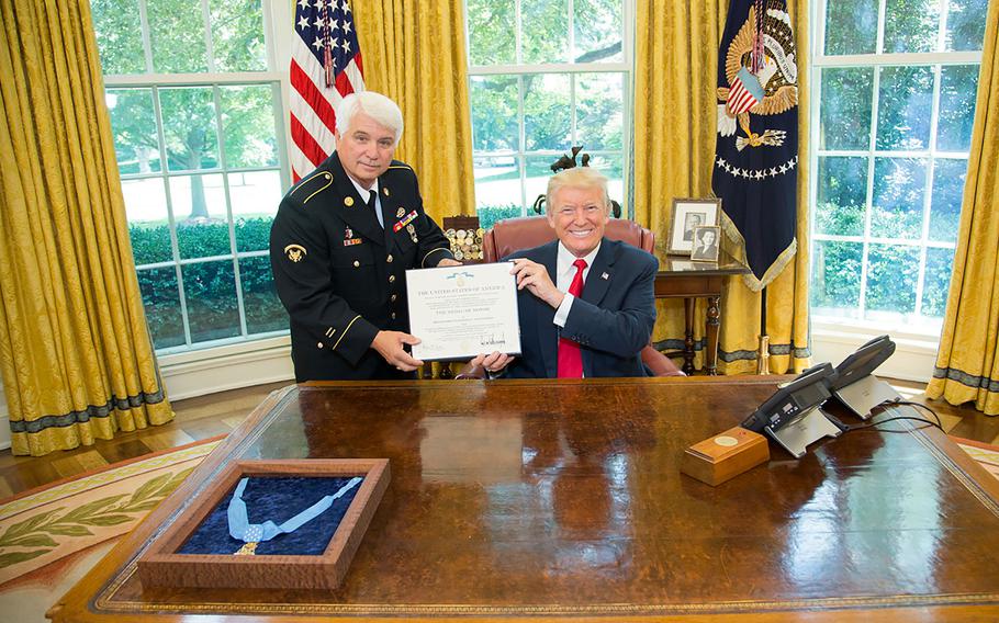 President Donald J. Trump poses in the Oval Office with James C. McCloughan on July 31, 2017. Trump awarded McCloughan the Medal of Honor.