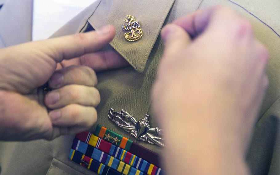 A chief hull technician receives his anchors during a chief petty officer pinning ceremony last year aboard the USS Green Bay.