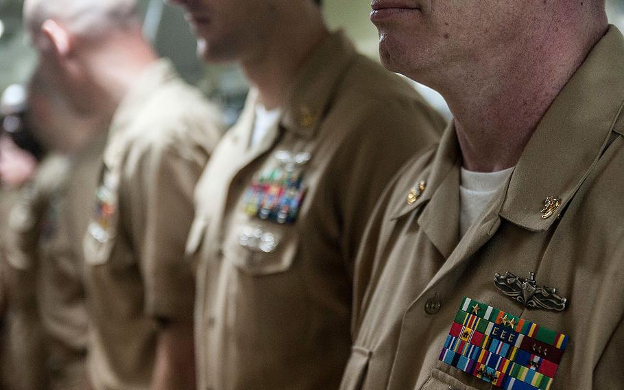 Newly-frocked Senior Chief Petty Officers stand in ranks during a pinning ceremony aboard the Nimitz-class aircraft carrier USS George Washington on May 29, 2015.