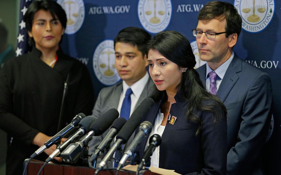 Faride Cuevas, second from right, a participant in the Deferred Action for Childhood Arrivals, or DACA, program, talks to reporters, Wednesday, Sept. 6, 2017, in Seattle, as Washington Attorney General Bob Ferguson, right, and two other DACA participants look on. 