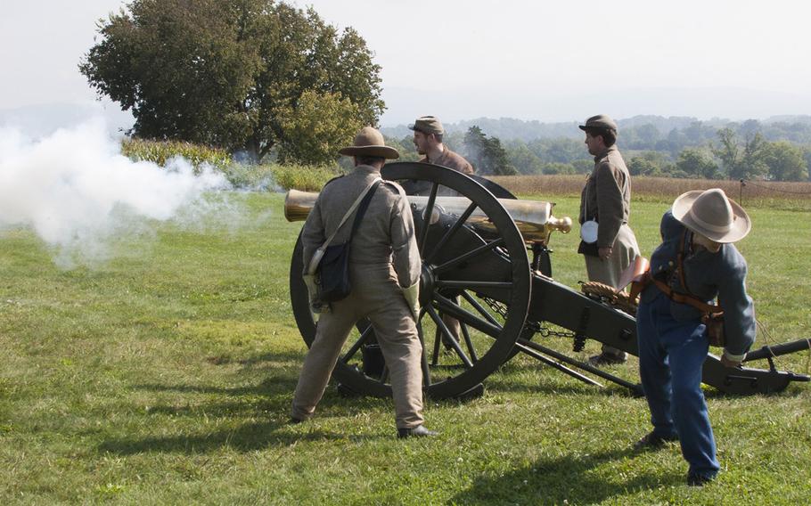 Civil War reenactors fire a cannon during ceremonies marking the 150th anniversary of the Antietam National Cemetery, Sept. 16-17, 2017 at Sharpsburg, Md.