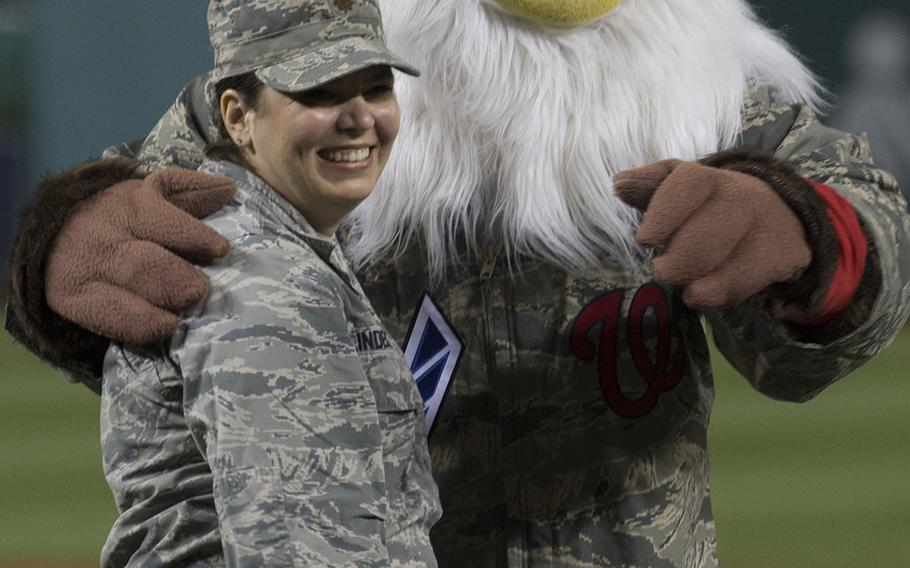 U.S. Air Force Maj. Jordan Lindeke poses with Washington Nationals mascot Screech after throwing the ceremonial first pitch on Air Force Night at Nationals Park in Washington, D.C., Sept. 17, 2017.